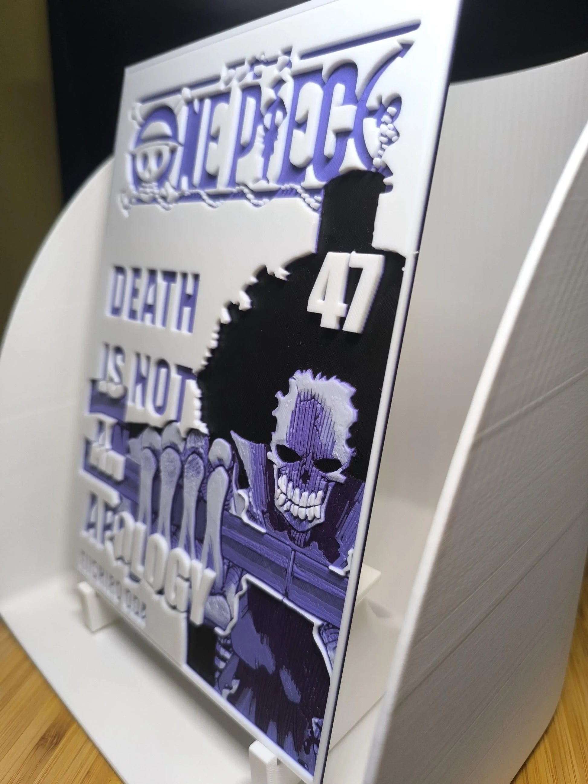 Plaque décorative One Piece avec texte 'Death is not a technology' et silhouette de personnage noir
