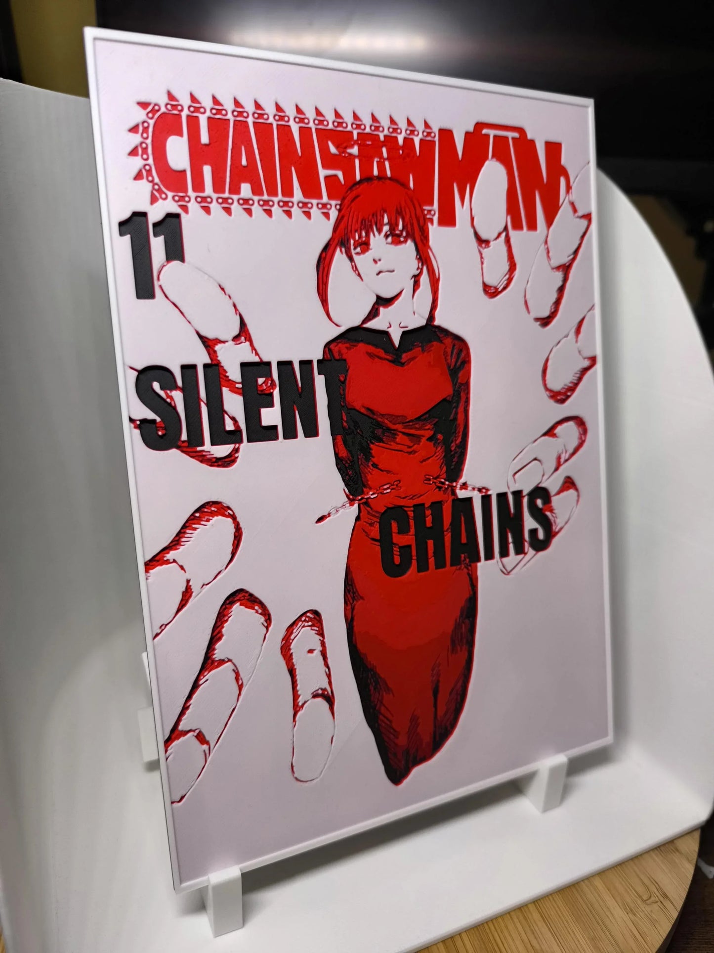 Couverture manga Chainsaw Man tome 11 avec personnage féminin en robe rouge et texte Silent Chains