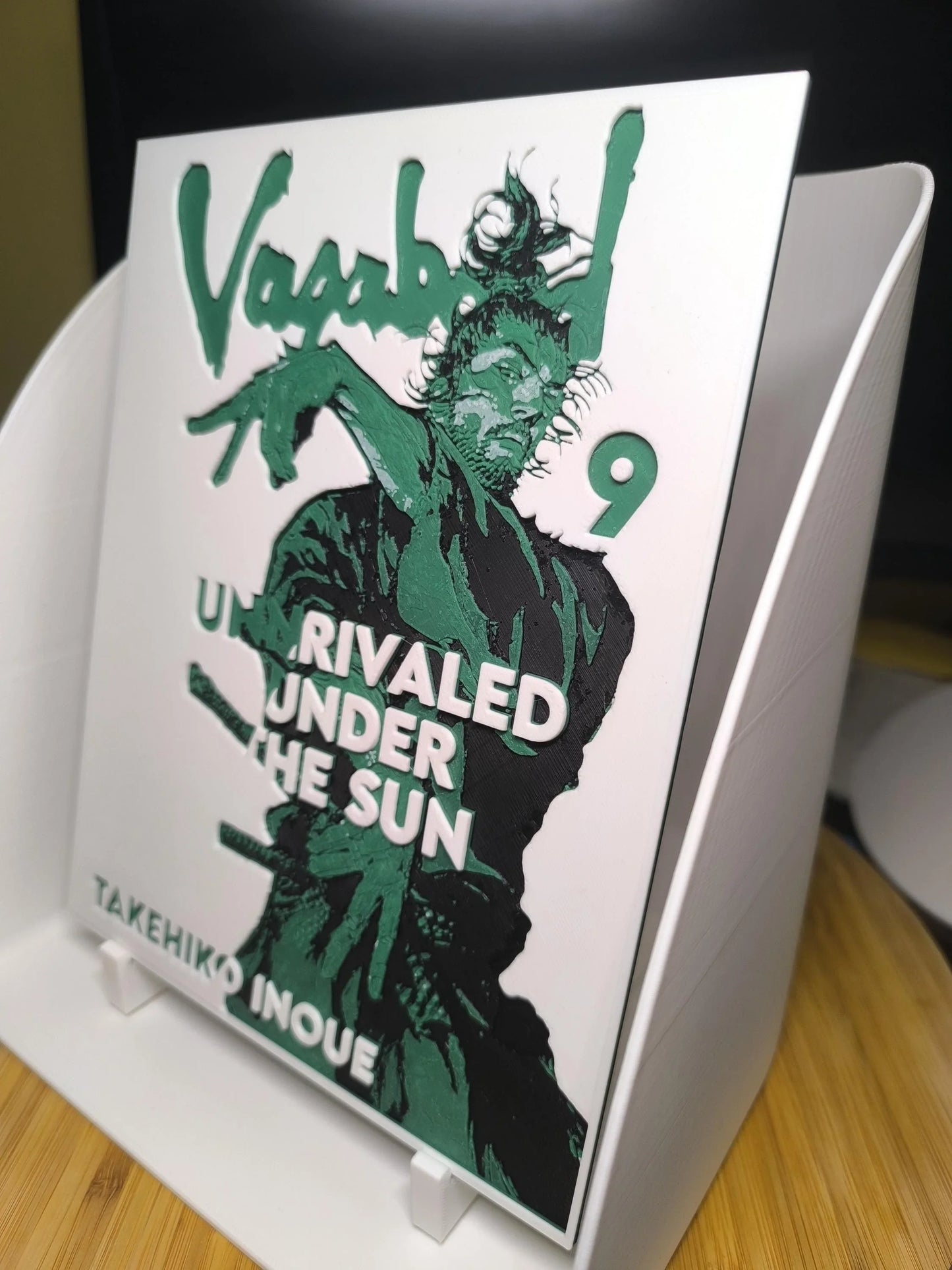 Couverture manga Vagabond tome 9 avec illustration homme en mouvement et texte en vert et blanc