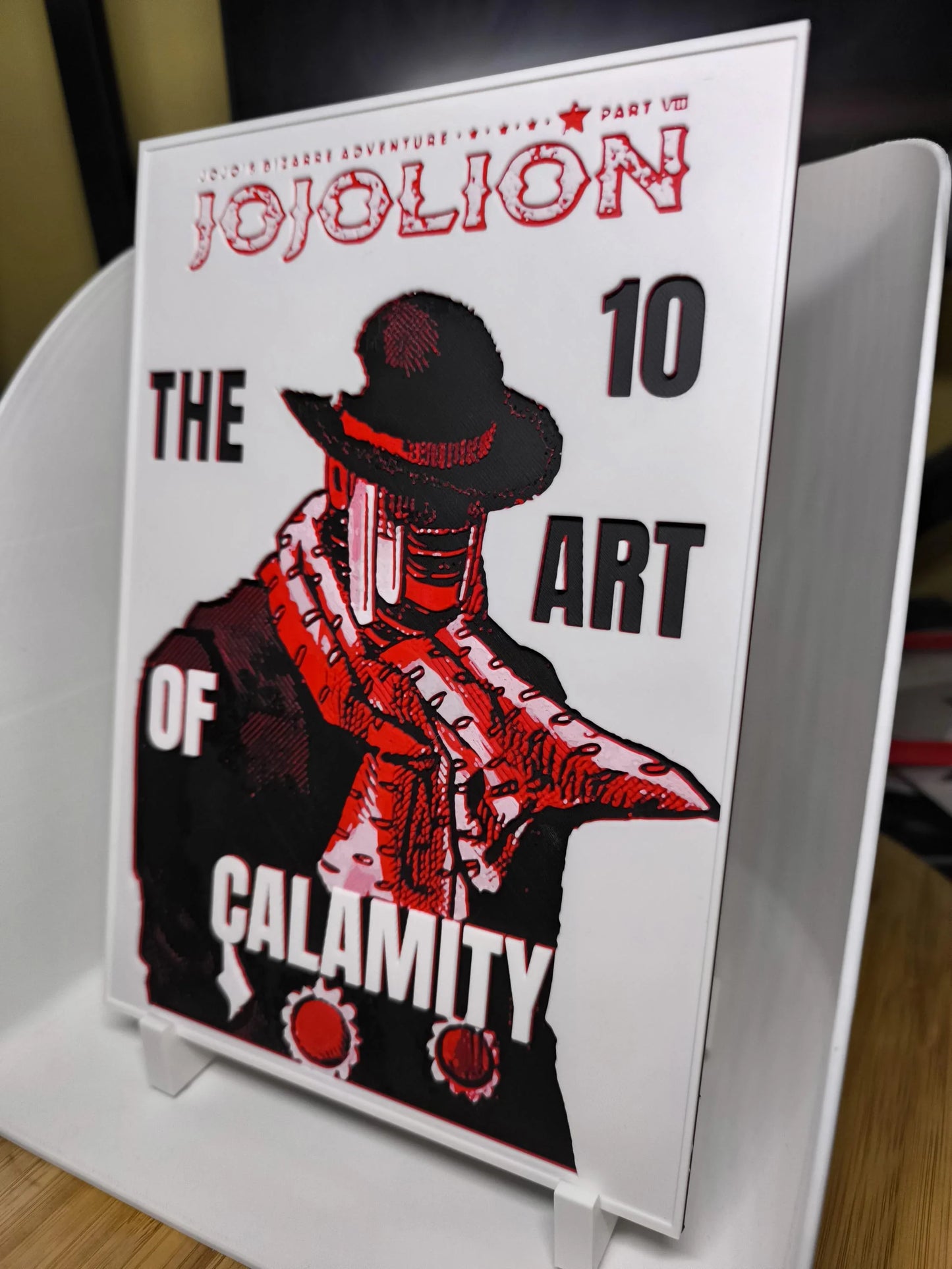 Couverture manga JoJolion The Art of Calamity volume 10 avec personnage en chapeau noir et écharpe rouge