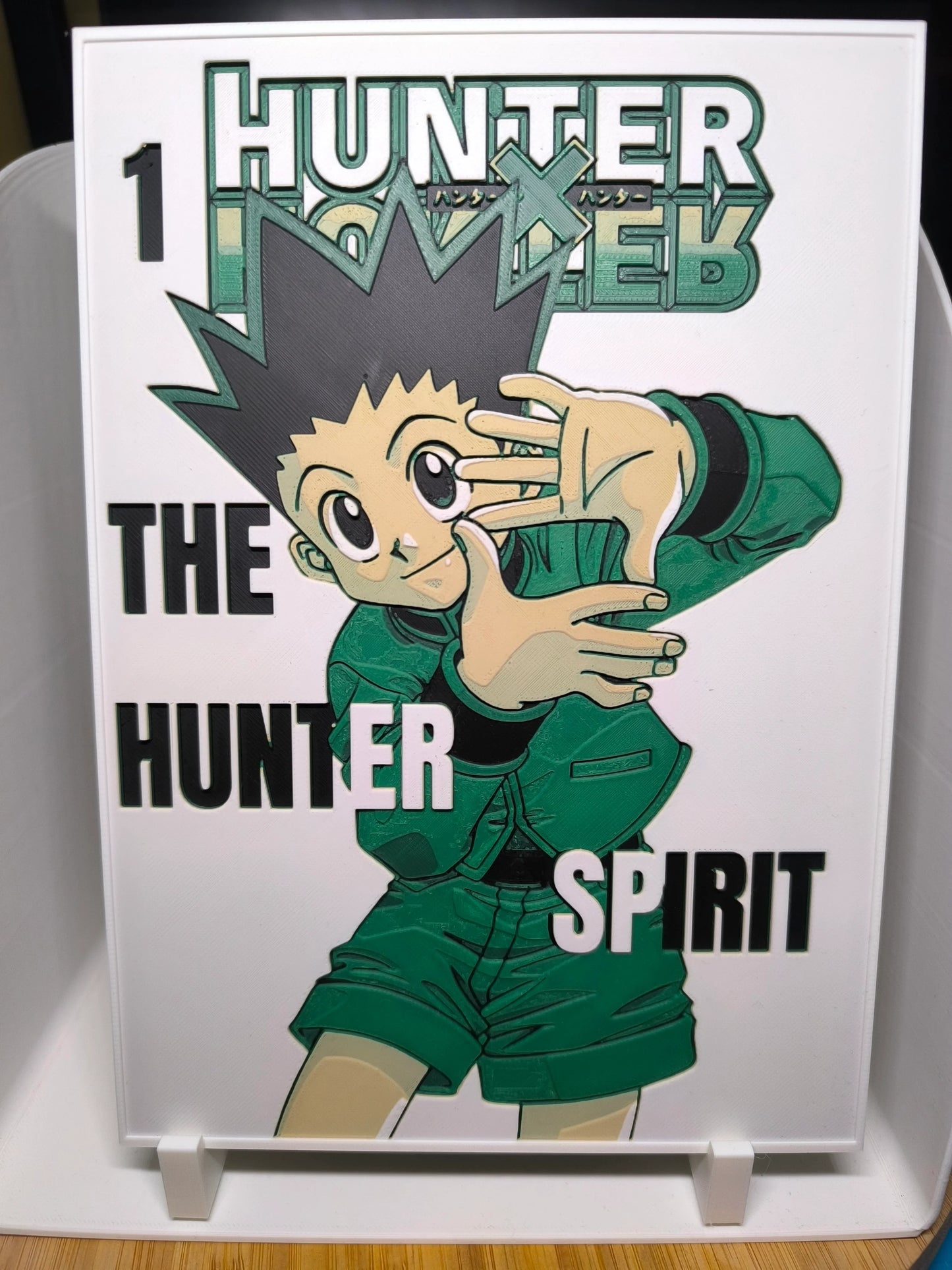 Couverture manga Hunter x Hunter n°1 avec personnage principal en tenue verte et cheveux noirs en pics