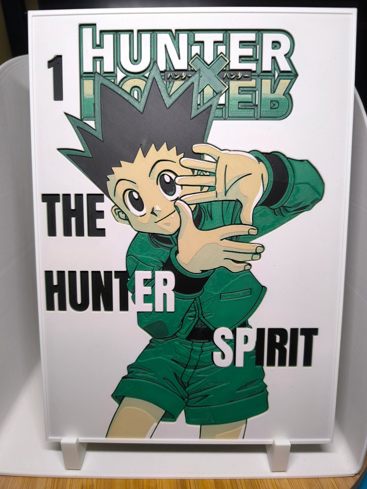Couverture manga Hunter x Hunter n°1 avec personnage principal en tenue verte et cheveux noirs en pics