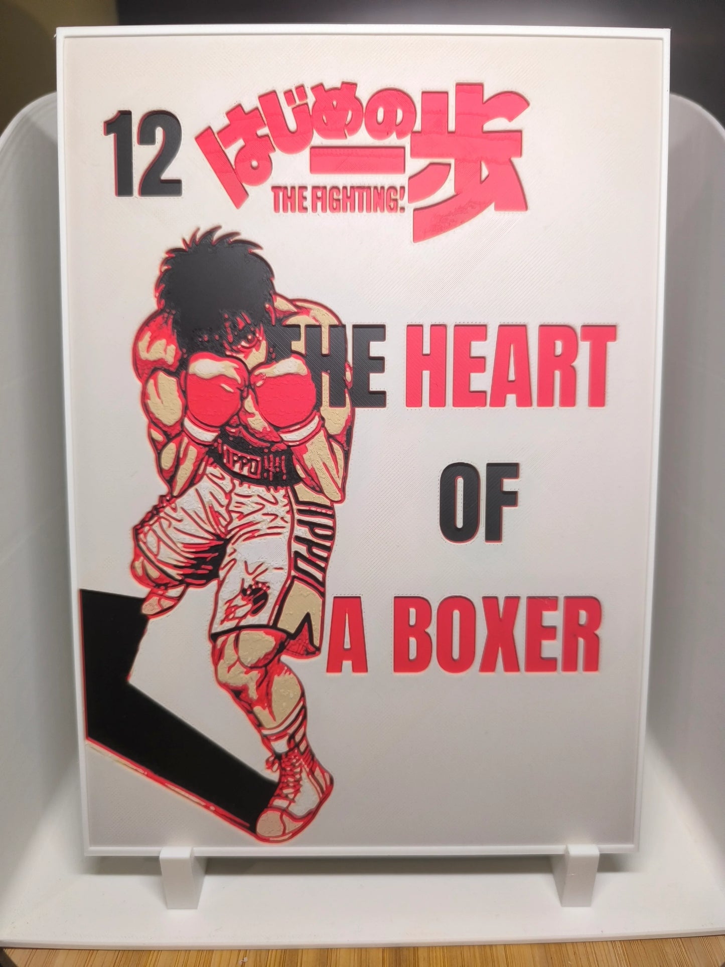 Couverture manga Hajime no Ippo Tome 12 avec boxeur en gants rouges et titre The Heart of a Boxer