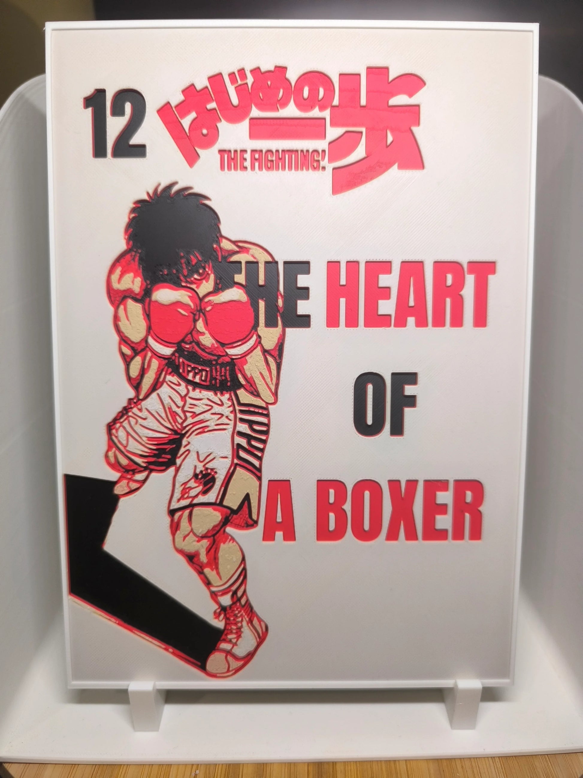 Couverture manga Hajime no Ippo Tome 12 avec boxeur en gants rouges et titre The Heart of a Boxer