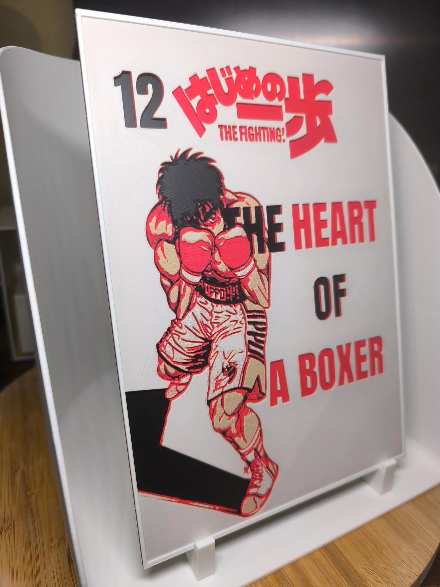 Couverture manga The Fighting! tome 12 avec un boxeur en position de combat, couleurs rouges et blanches