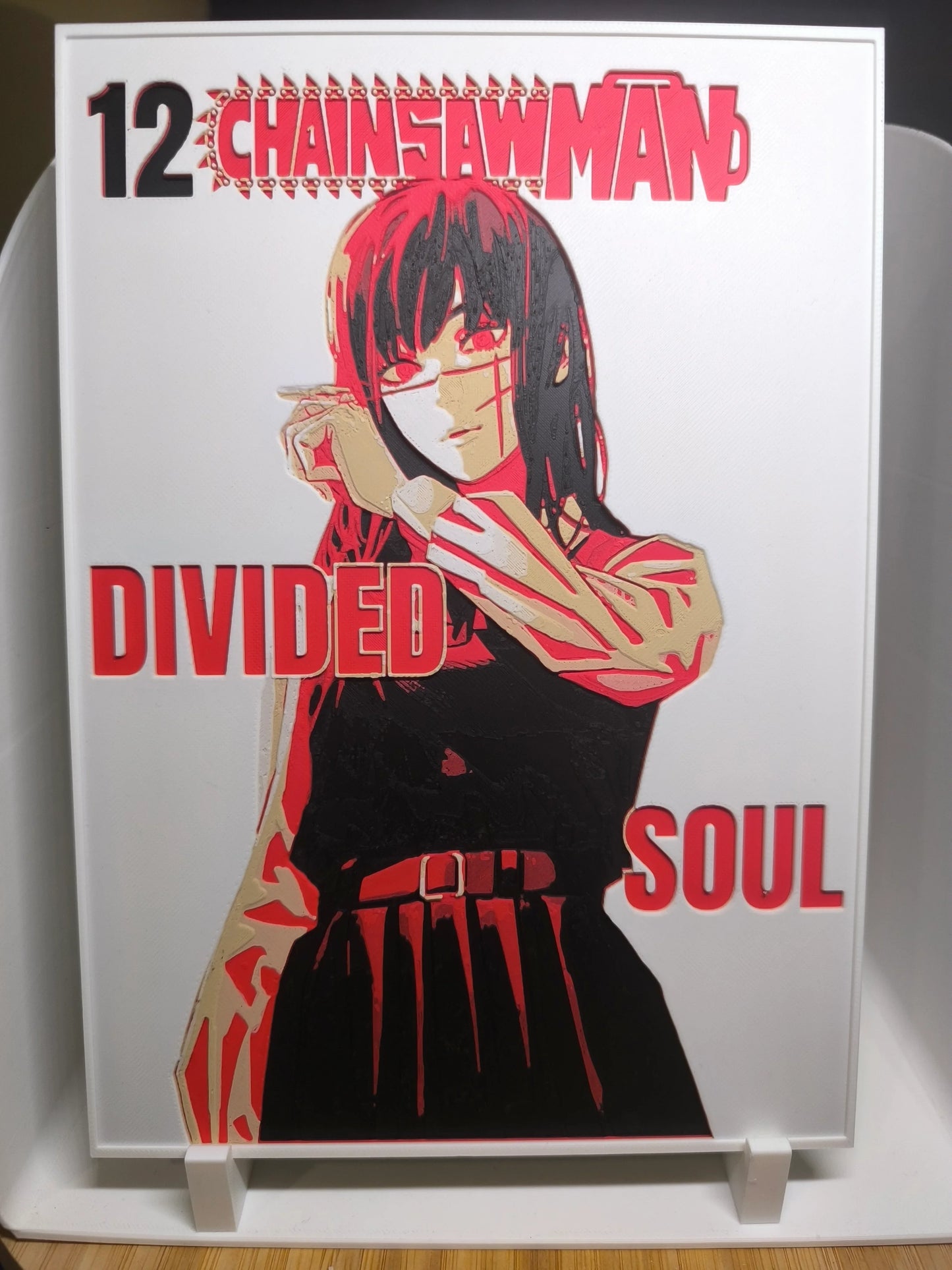 Couverture manga Chainsaw Man volume 12 avec personnage féminin et texte Divided Soul