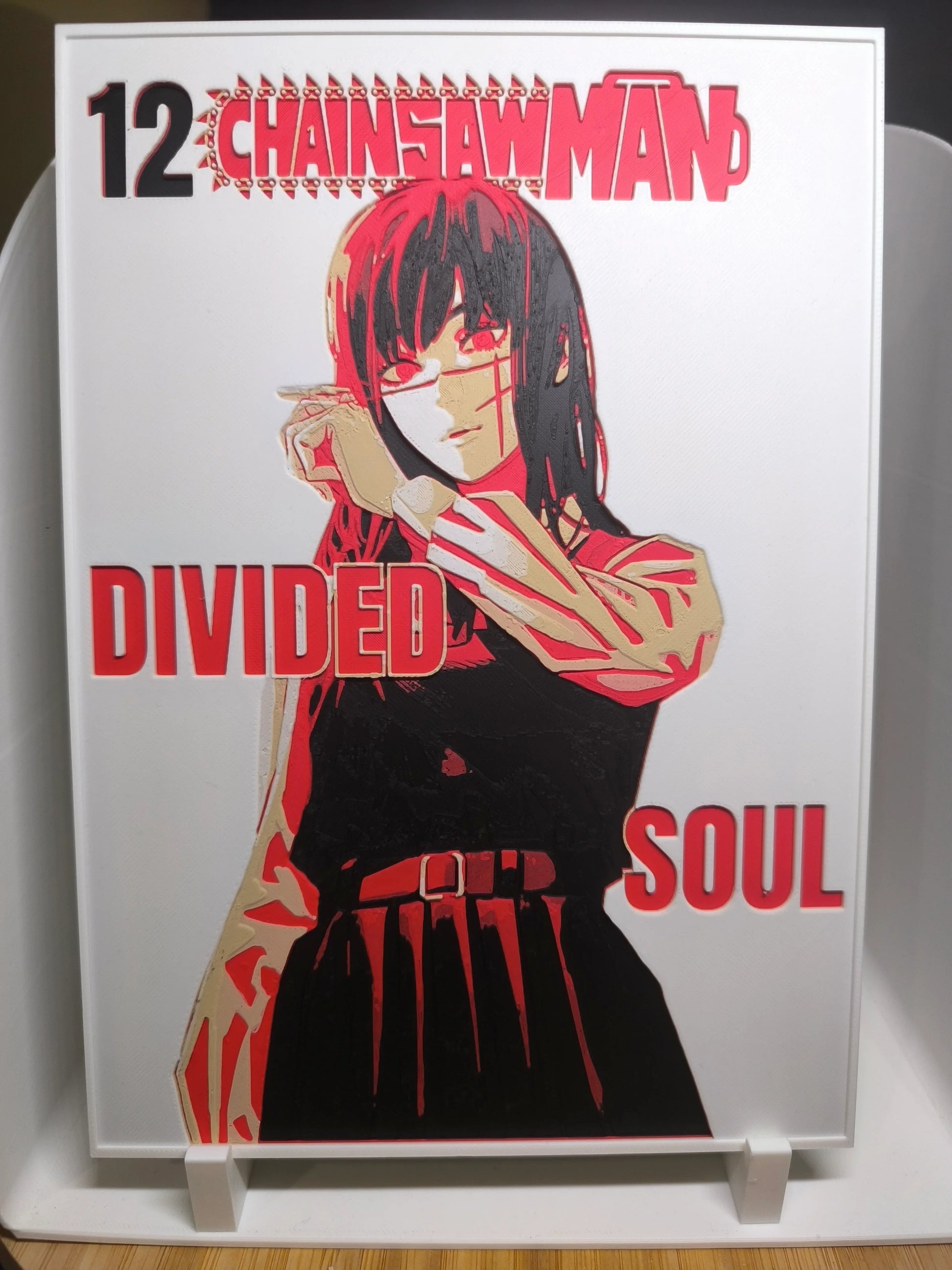 Couverture manga Chainsaw Man volume 12 avec personnage féminin et texte Divided Soul