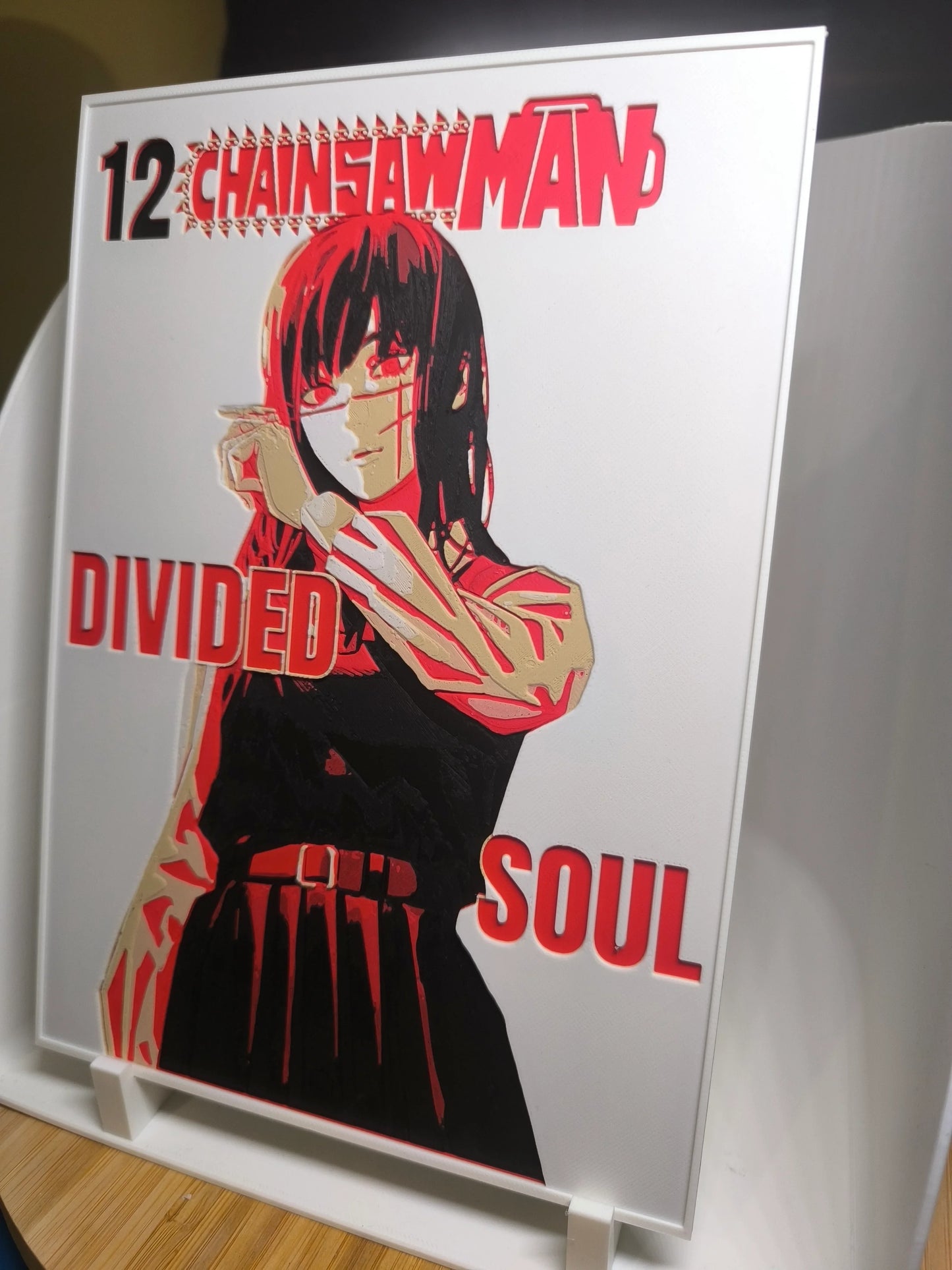 Illustration personnage manga Chainsaw Man volume 12 Divided Soul avec effets rouges et noirs sur fond blanc