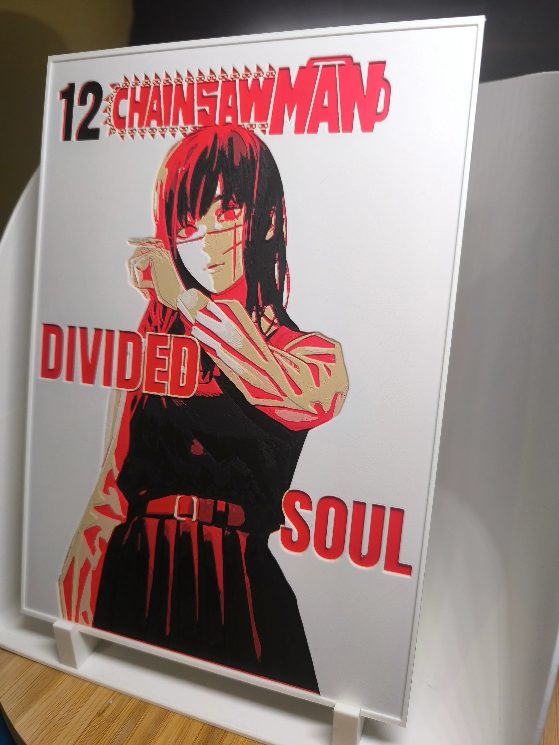 Illustration personnage manga Chainsaw Man volume 12 Divided Soul avec effets rouges et noirs sur fond blanc