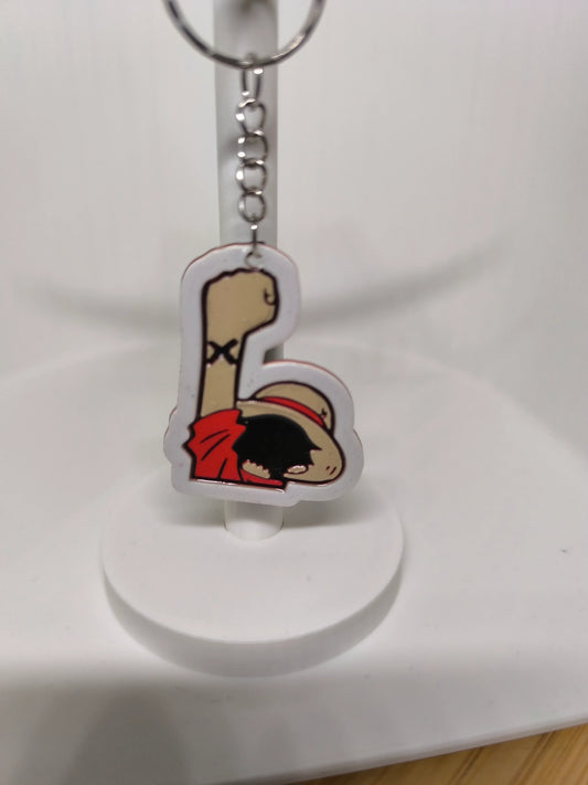 Porte-clés en acrylique avec dessin de poing levé et personnage en chapeau de paille rouge