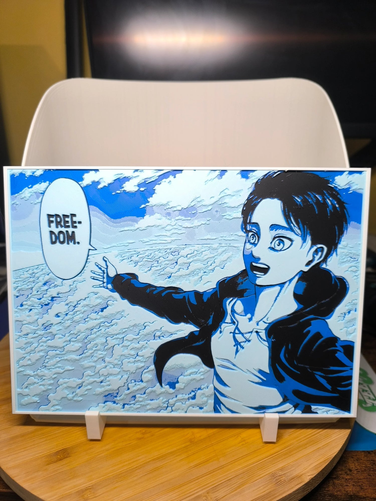 Tableau manga bleu noir montrant un personnage criant « FREEDOM » devant un ciel nuageux
