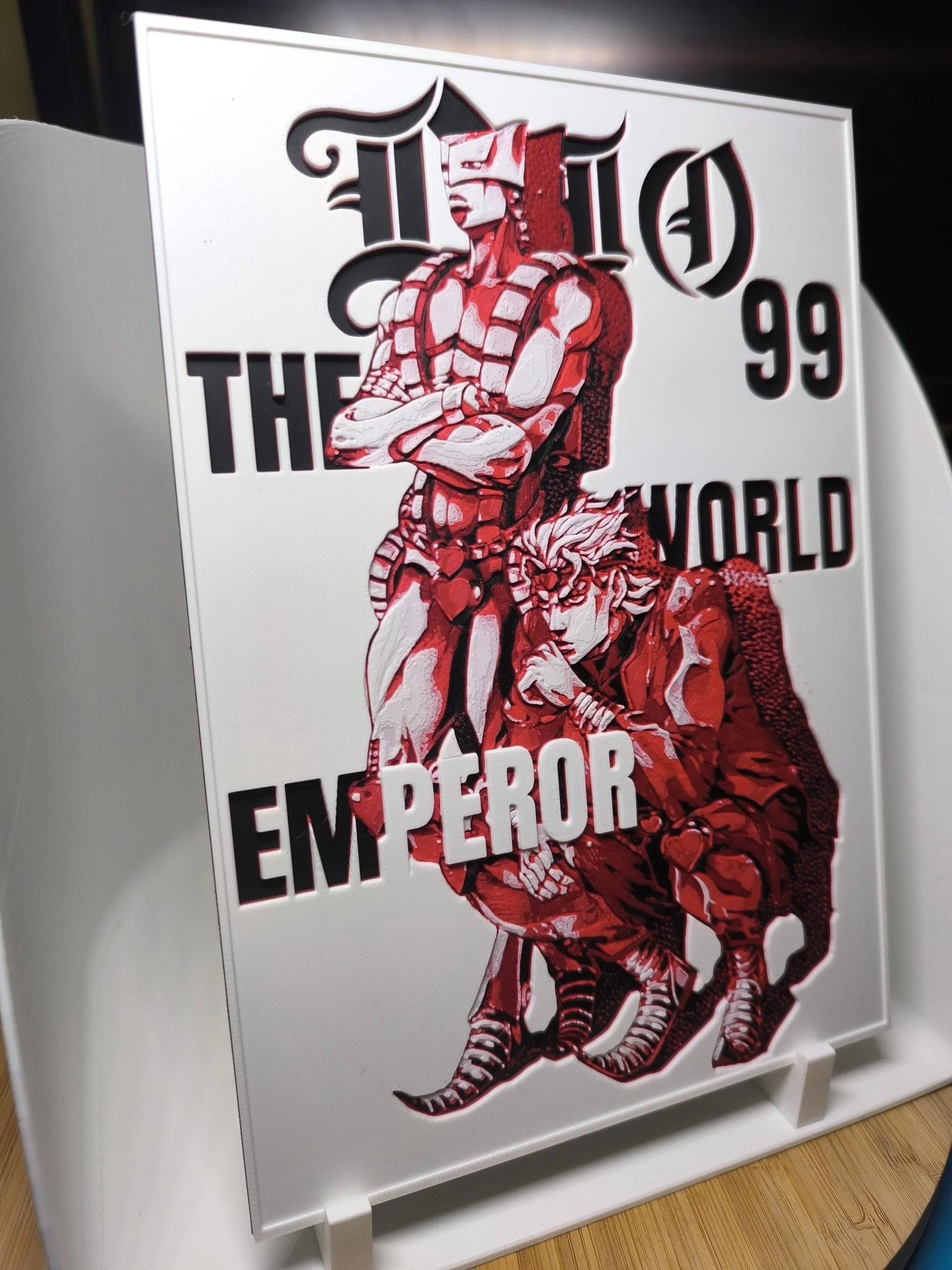 Illustration en rouge de deux personnages stylisés, l'un debout et l'autre accroupi, texte "The World Emperor"